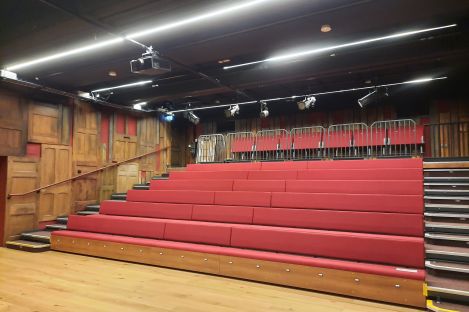 Rows of red tiered seating in our Woodshed Theatre