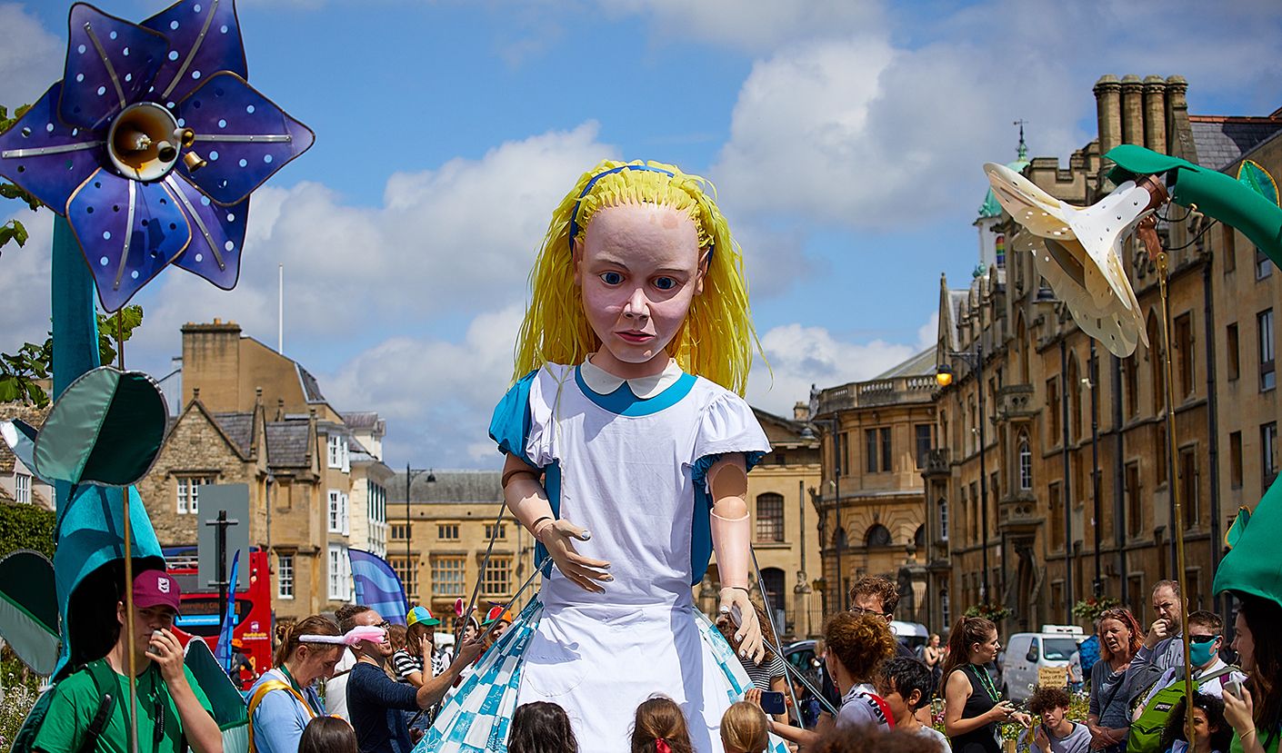 A giant puppet Alice in the streets of Oxford