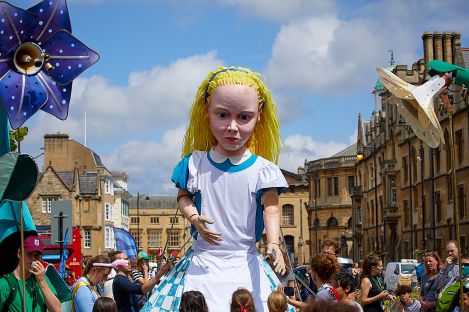 A giant puppet Alice in the streets of Oxford