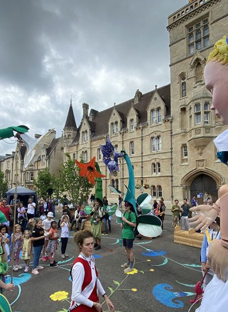 A giant puppet Alice and a crowd