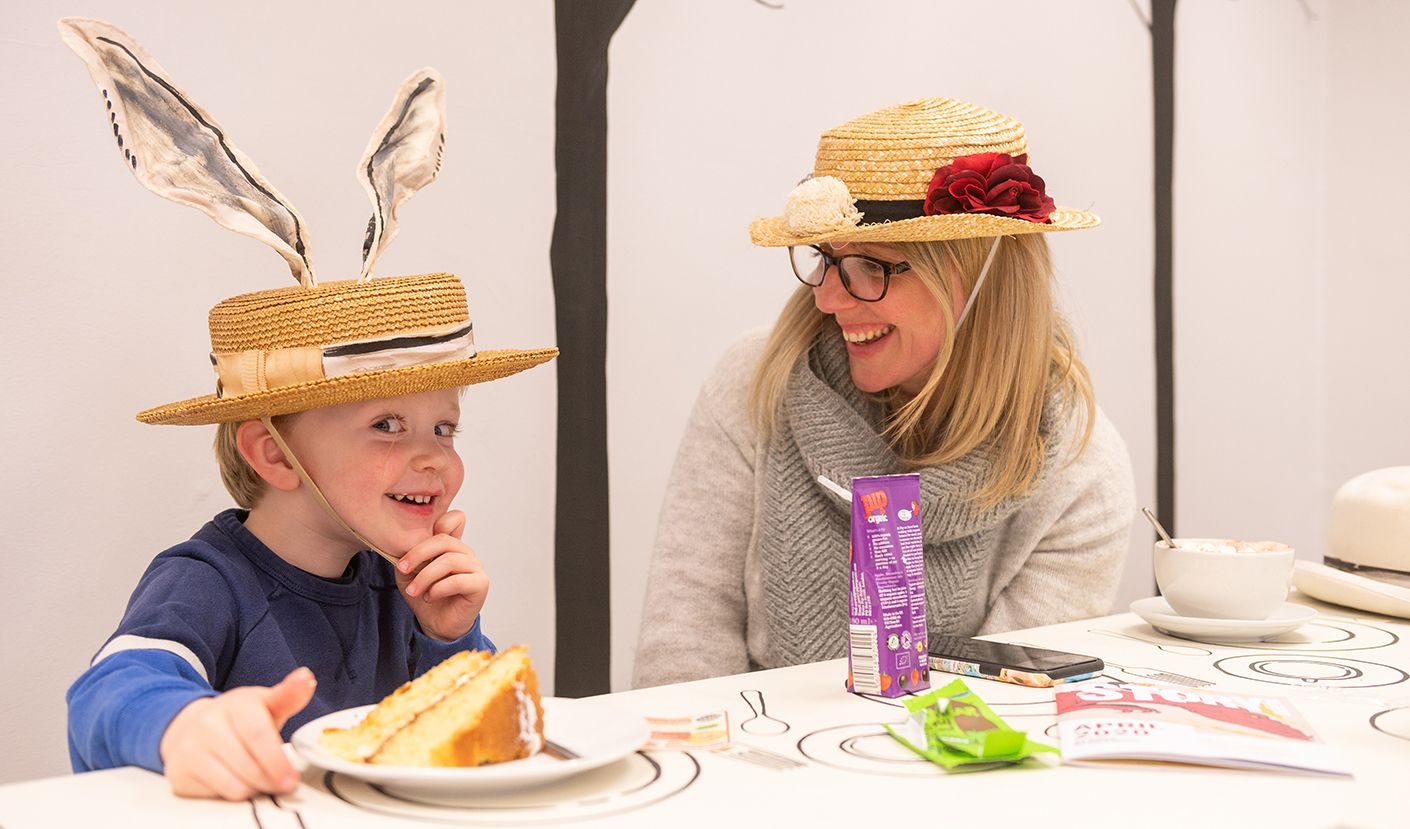 Child wearing hat with rabbit ears in a cafe