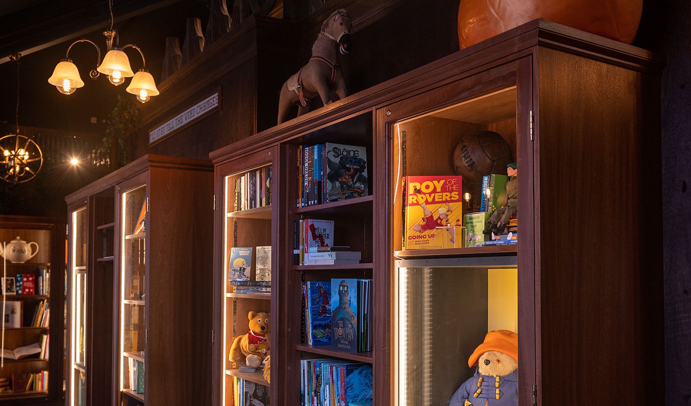 Shelves and display cabinets lit up in the Enchanted Library.