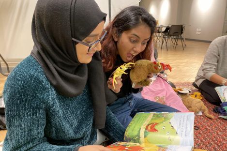 Two university students looking at a picture book