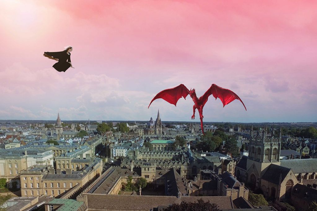 A witch and dragon flying over Oxford.