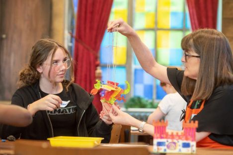 A Story Leader and a child doing a craft activity
