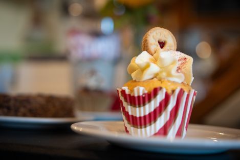 An iced cupcake topped with red sparkles