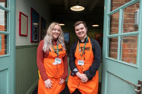 A male and female Story Guide standing in the entrance to the Portal
