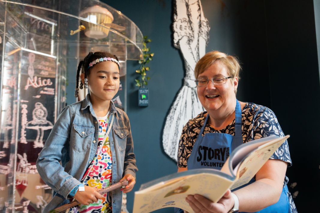 A volunteer reading with a child