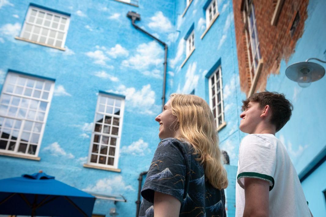 Two teenagers gazing up at our Blue Sky courtyard