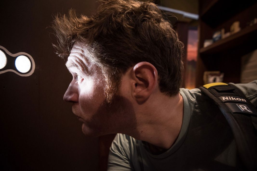 Man looking into a peephole