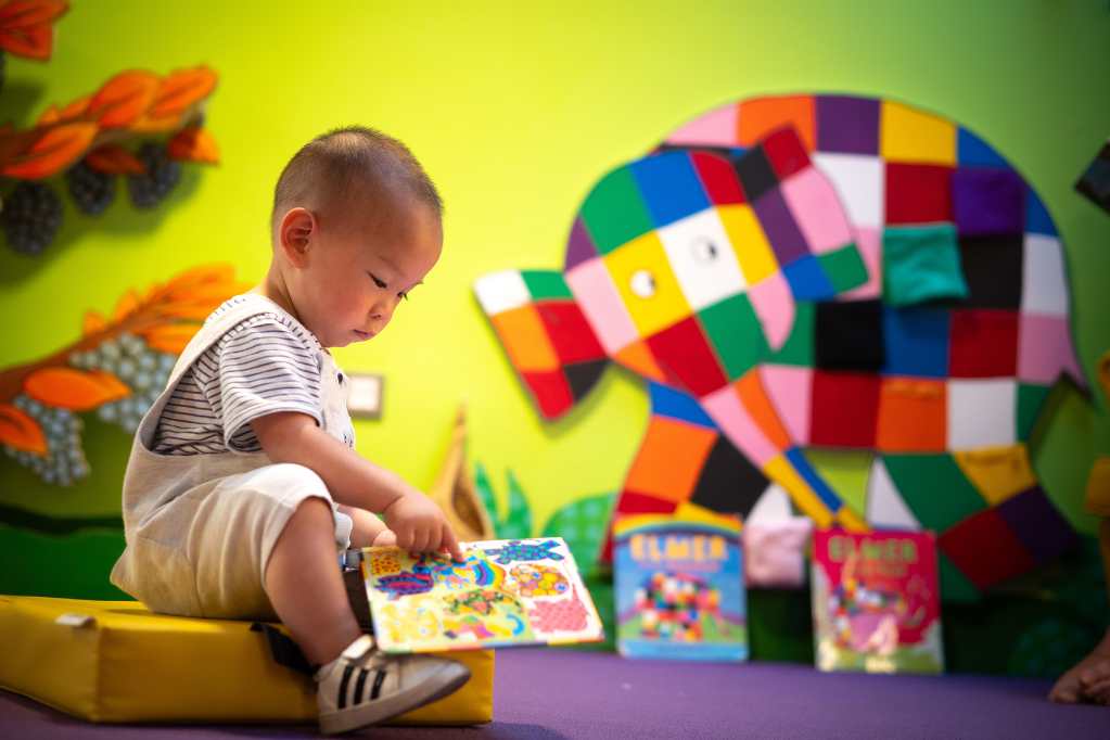 Child reading in Small Worlds